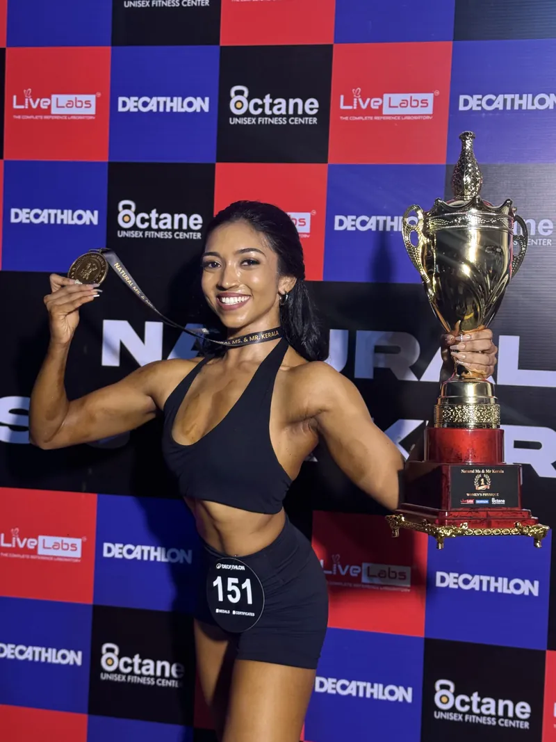 Irine on stage with her competition trophy and medal